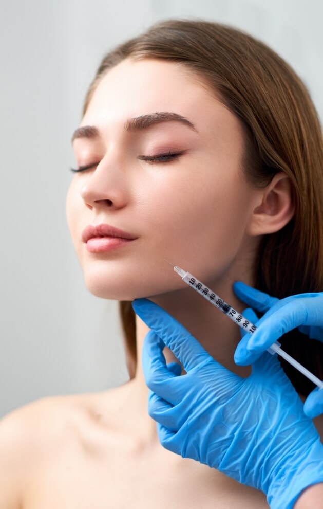 Woman receiving an injection on the face