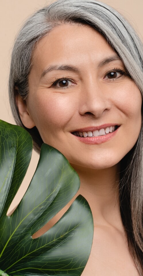 Middle aged woman holding a leaf